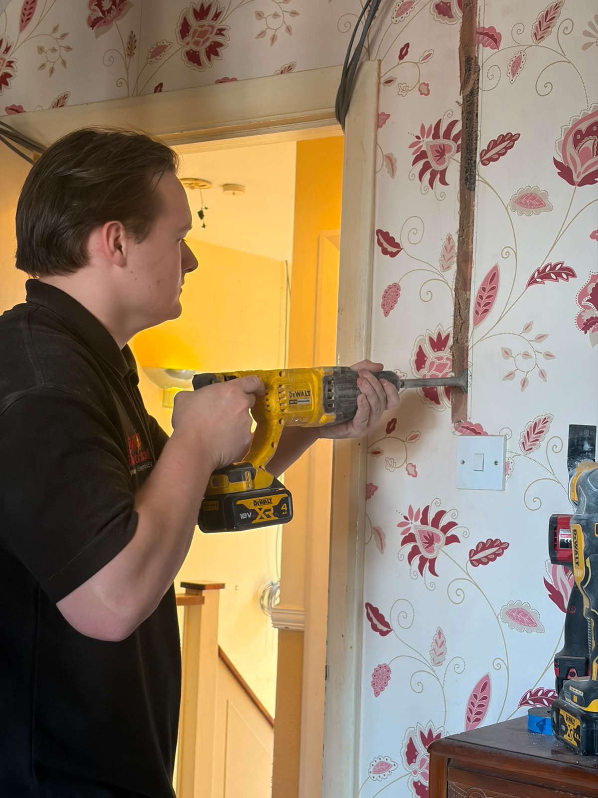 Engineer chasing a wall to run new cables during a full house rewire