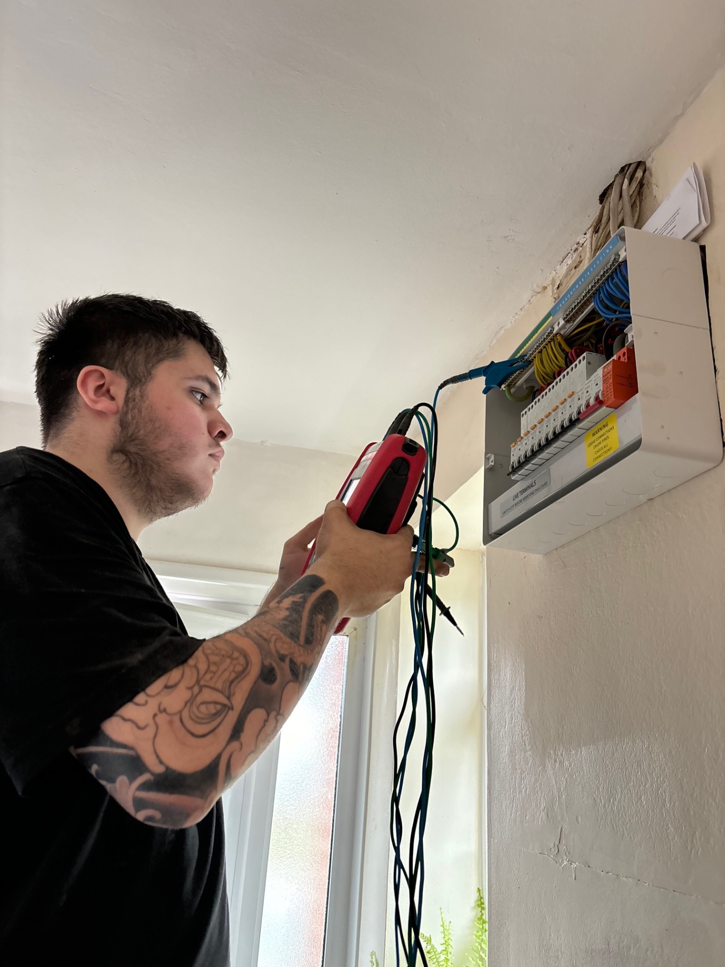 Engineer testing electrical installation with diagnostic equipment