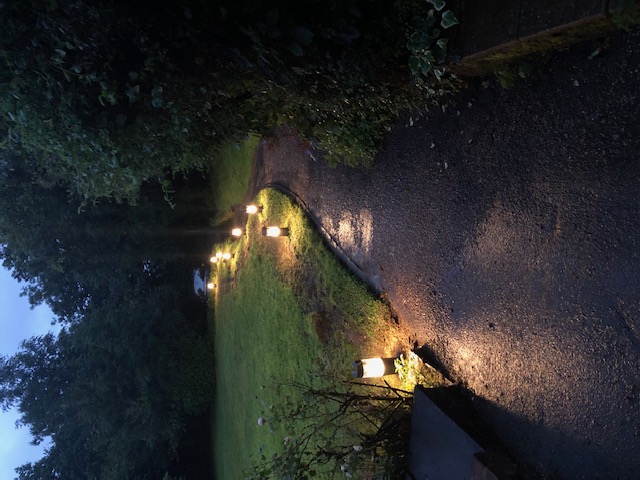 LED pathway bollard lights illuminating garden path at dusk