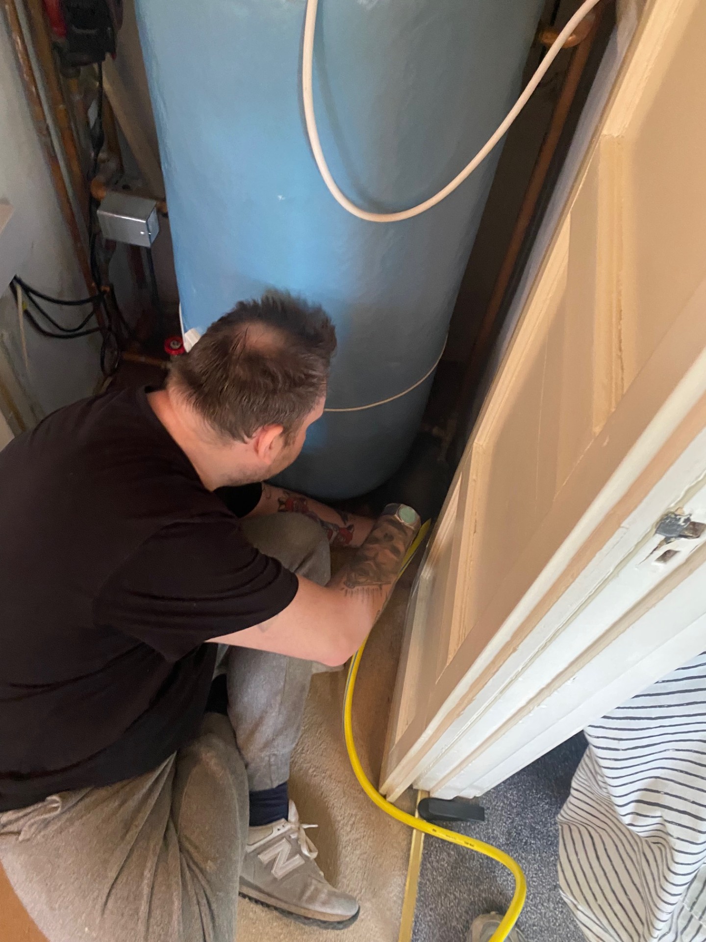 Engineer working on immersion heater installation