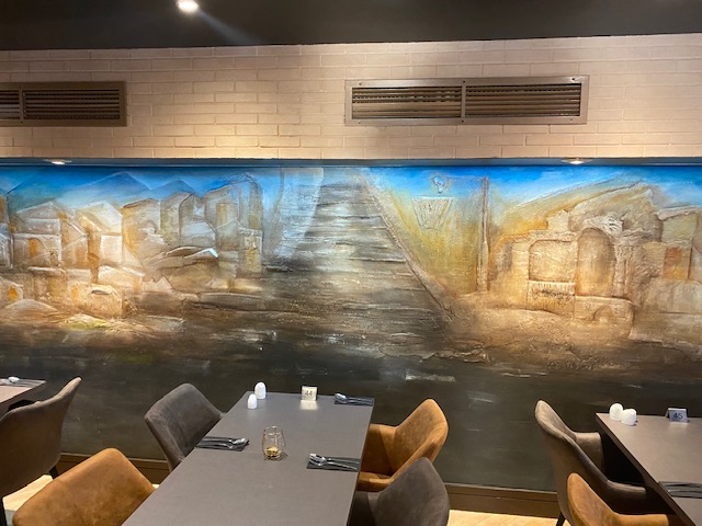 Restaurant wall mural with accent lighting